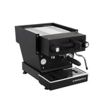 A La Marzocco Linea Mini espresso machine with a white body, black accents, and a stainless steel top.
