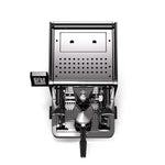 A top-down view of a sleek, modern espresso machine with a brushed silver metal body and black accents, set against a solid white background.