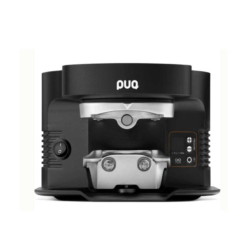 A black and silver countertop coffee maker by PUQ, shown from a top-down view on a white background.